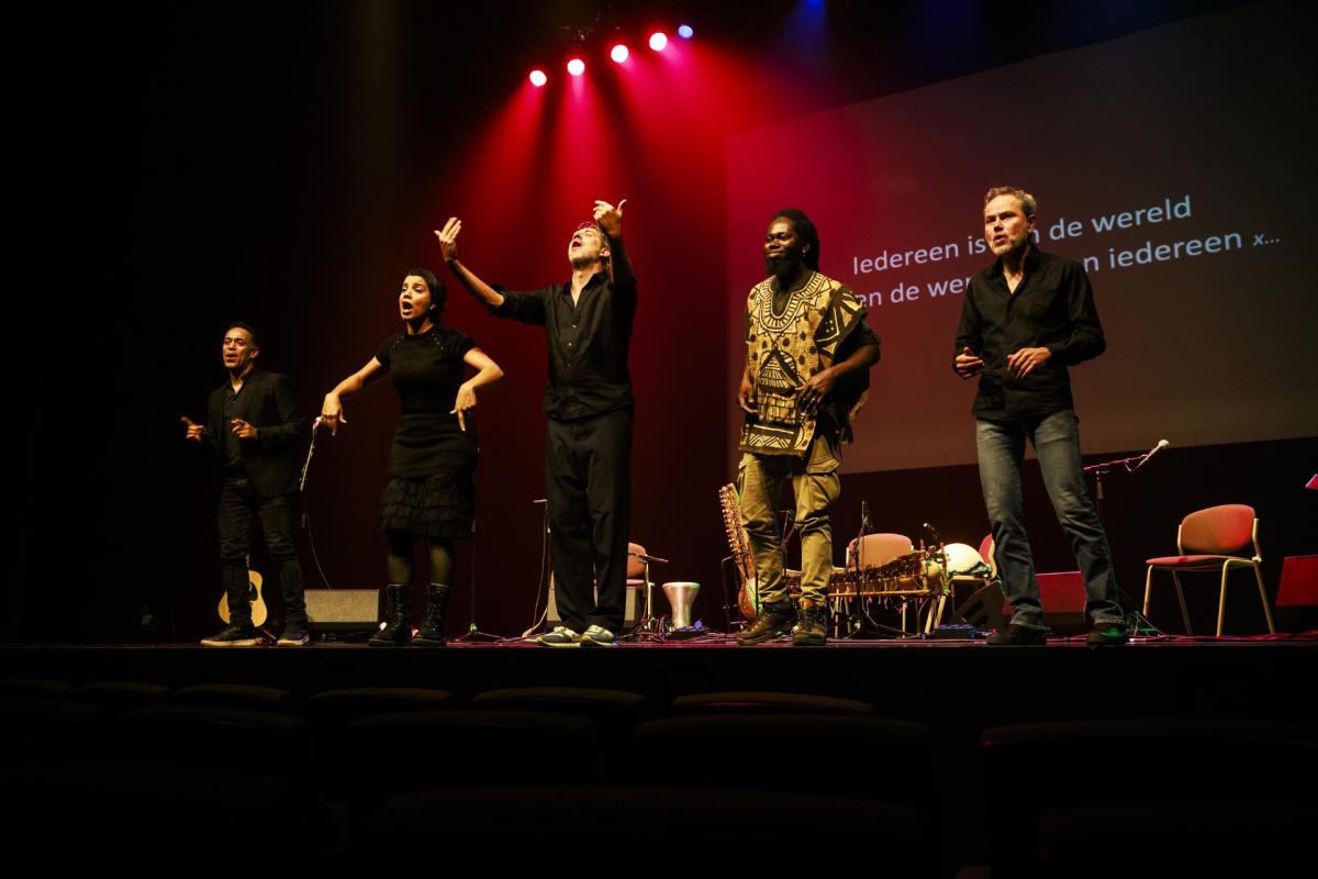 vijf artiesten op een podium
